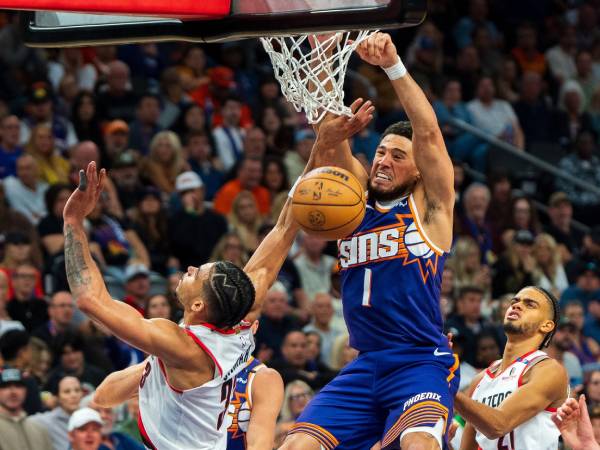 Devin Booker (tengah) mencetak 28 poin saat Phoenix Suns menang 103-97 atas Portland Trail Blazers pada Sabtu (2/11) malam. (Foto: AP)